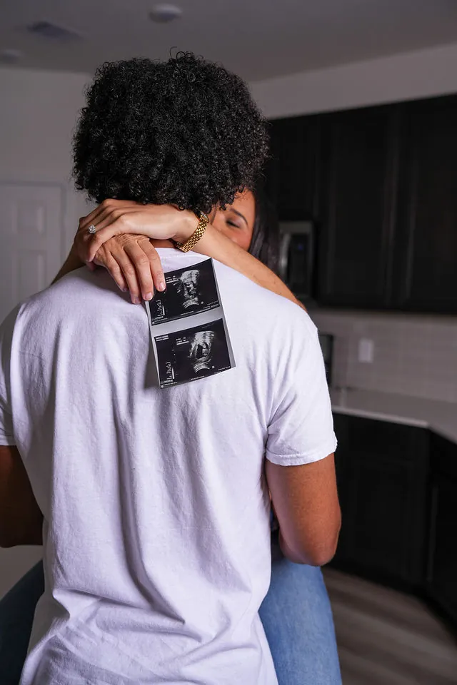 Expecting parents holding an ultrasound photo